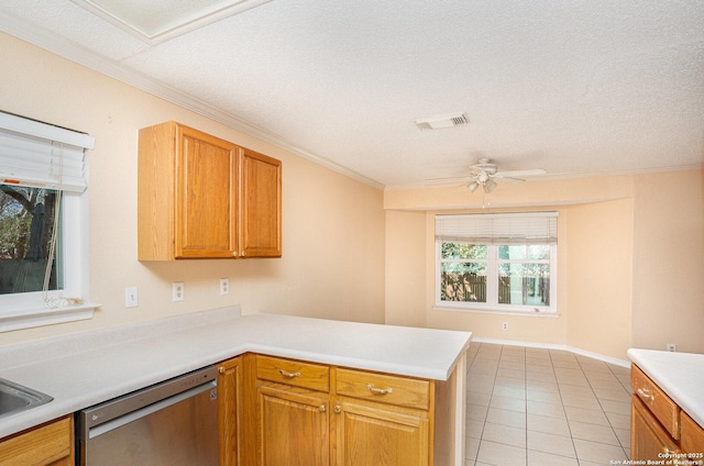 kitchen with light tile patterned floors, visible vents, dishwasher, a peninsula, and light countertops