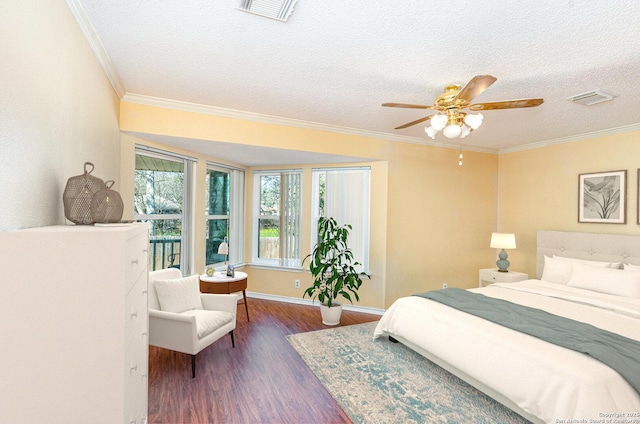 bedroom with dark wood-style floors, visible vents, and crown molding