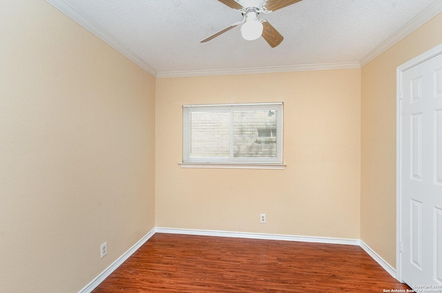 unfurnished room featuring crown molding, baseboards, and wood finished floors