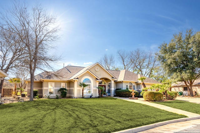 view of front of home with stucco siding and a front yard