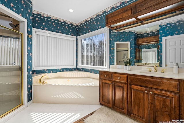 bathroom featuring wallpapered walls, a shower stall, a bath, and vanity