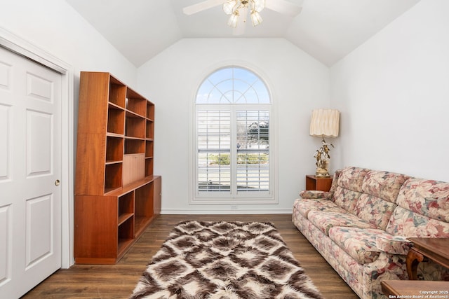 living room featuring lofted ceiling, dark wood-style floors, and a ceiling fan