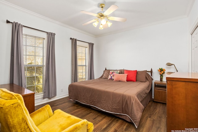 bedroom with dark wood-style floors, crown molding, and a ceiling fan