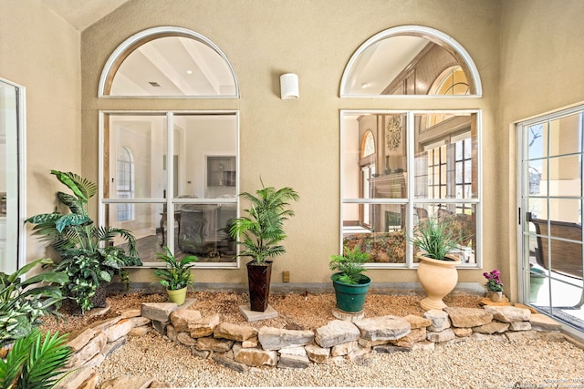 entrance to property featuring stucco siding