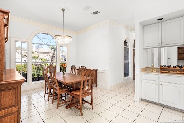 dining space with a chandelier, visible vents, crown molding, and light tile patterned floors