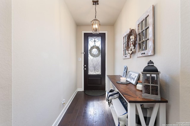 entryway featuring dark wood-type flooring and baseboards