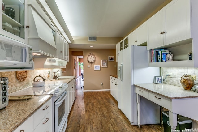 kitchen featuring white appliances, visible vents, white cabinets, dark wood-type flooring, and a sink