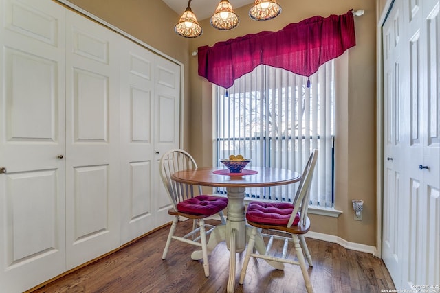 dining area featuring wood finished floors and baseboards