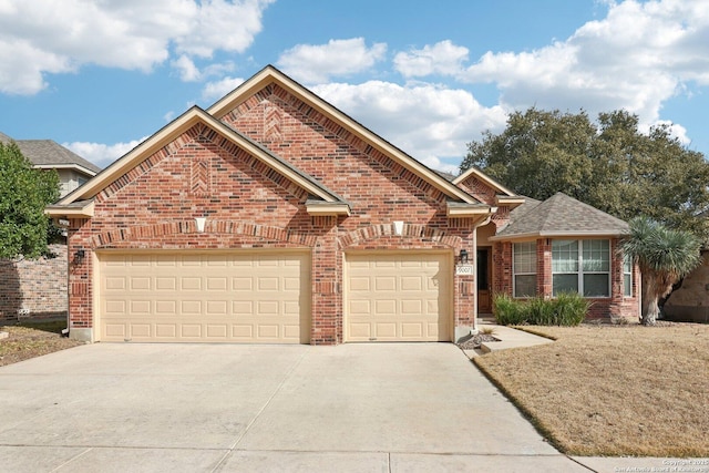 view of front facade with a garage, driveway, and brick siding