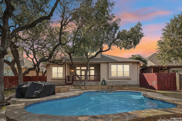 view of pool with area for grilling, fence, and a fenced in pool