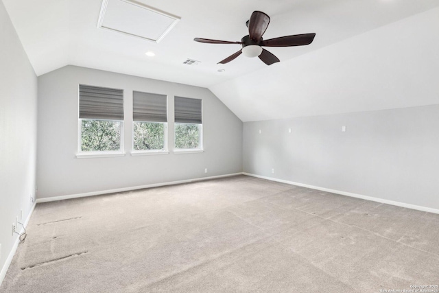 additional living space featuring lofted ceiling, carpet flooring, visible vents, and baseboards