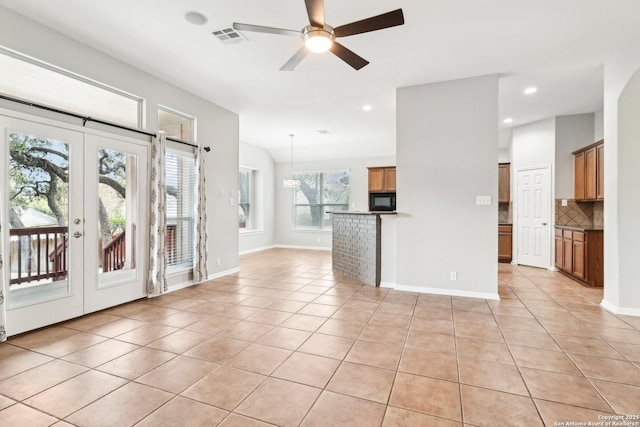 interior space featuring light tile patterned floors, visible vents, baseboards, a ceiling fan, and french doors