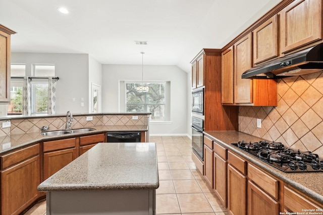 kitchen featuring visible vents, brown cabinetry, a sink, under cabinet range hood, and black appliances