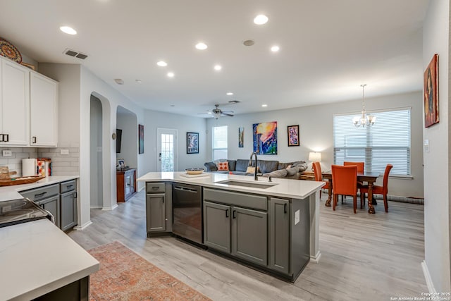 kitchen with light countertops, visible vents, a sink, and stainless steel dishwasher