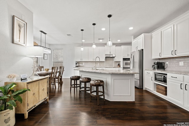 kitchen featuring stainless steel appliances, dark wood-type flooring, white cabinetry, and under cabinet range hood