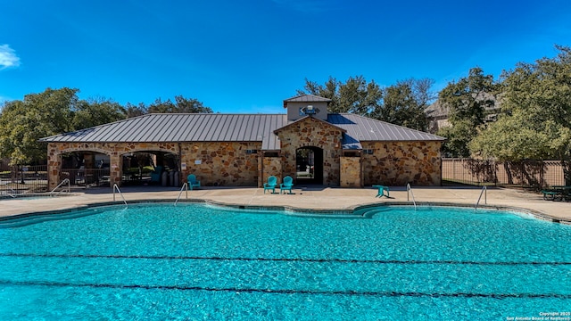 pool with fence and a patio