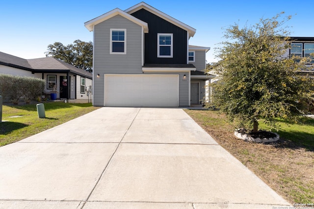 view of front facade with board and batten siding, a front lawn, driveway, and an attached garage