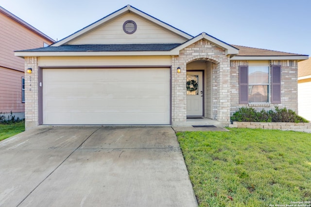 ranch-style house featuring brick siding, a shingled roof, concrete driveway, an attached garage, and a front yard