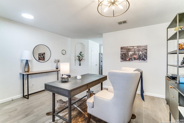 office with baseboards, visible vents, and light wood finished floors