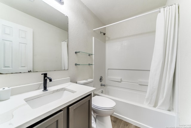 bathroom with toilet, shower / bath combo with shower curtain, wood finished floors, and vanity