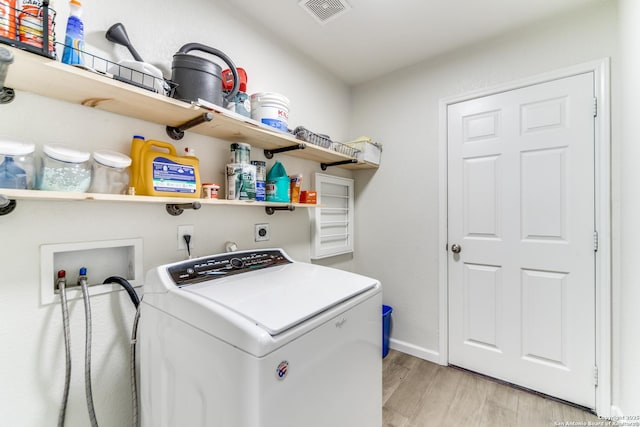 laundry room featuring laundry area, visible vents, baseboards, light wood-type flooring, and washer / clothes dryer