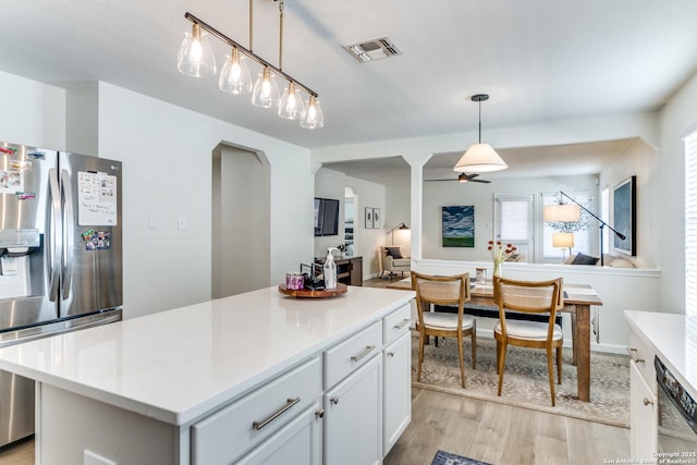 kitchen with stainless steel fridge, visible vents, dishwashing machine, light wood-style flooring, and light countertops