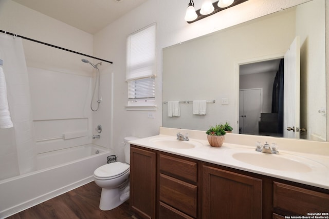 bathroom featuring double vanity, toilet, shower / bathtub combination with curtain, and a sink