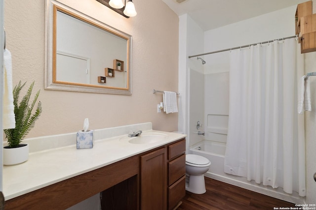 bathroom featuring vanity, wood finished floors, toilet, and shower / bathtub combination with curtain