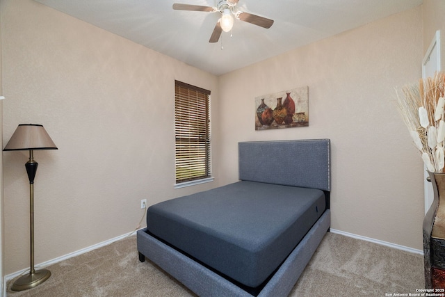 carpeted bedroom featuring a ceiling fan and baseboards