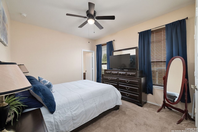 carpeted bedroom with baseboards and ceiling fan
