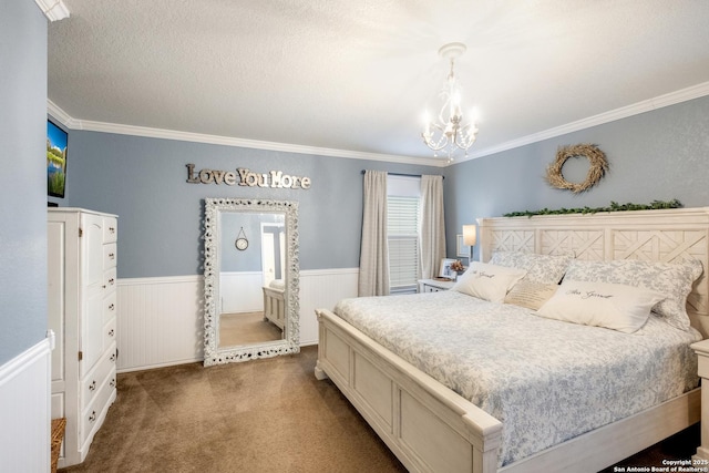 carpeted bedroom featuring crown molding, wainscoting, a notable chandelier, and a textured ceiling