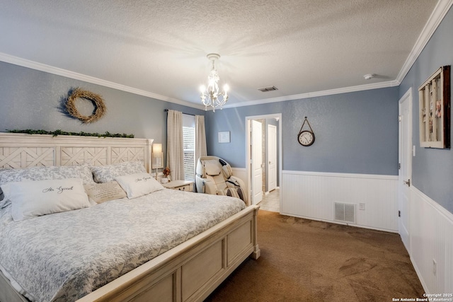 carpeted bedroom featuring wainscoting, visible vents, a textured ceiling, and an inviting chandelier
