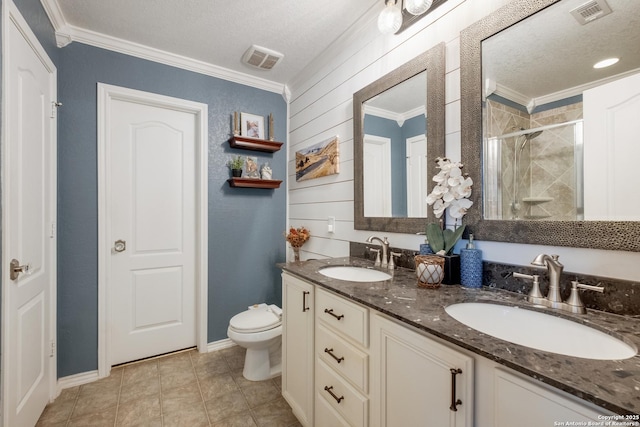 bathroom with a stall shower, a sink, visible vents, and crown molding