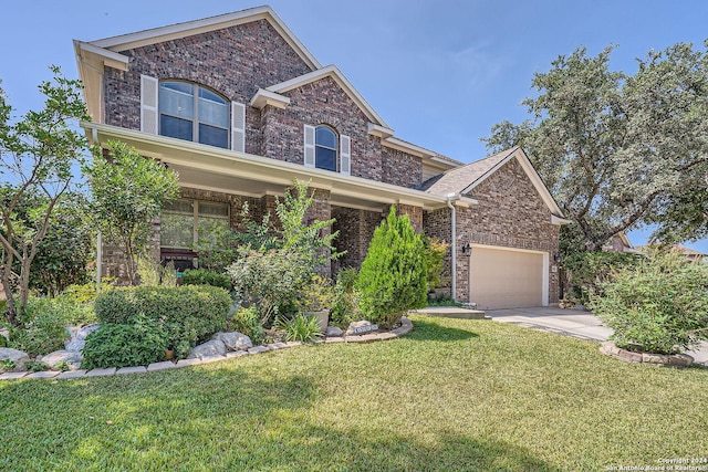 view of front of property with driveway, brick siding, and a front lawn