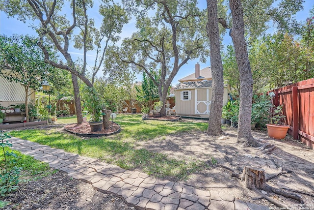 13026 Gordons Knl, San Antonio, TX 78253 - view of yard featuring an outbuilding, a storage unit, and a fenced backyard