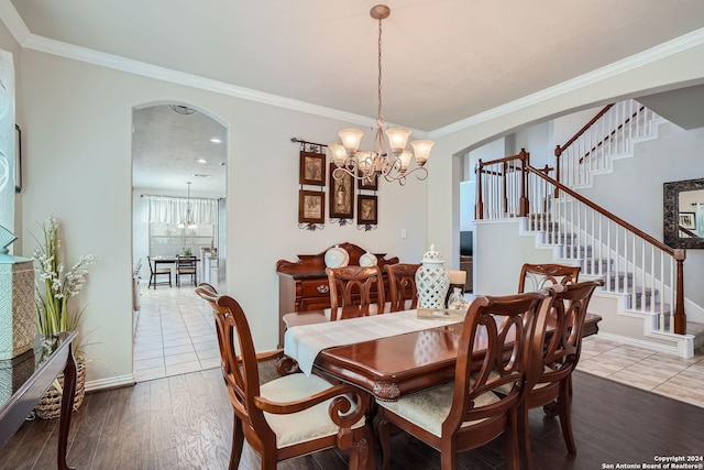 13026 Gordons Knl, San Antonio, TX 78253 - dining space featuring a chandelier, arched walkways, crown molding, and stairs