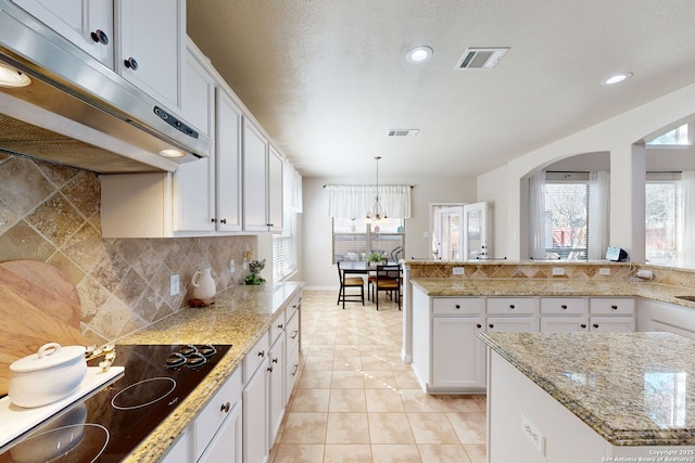 13026 Gordons Knl, San Antonio, TX 78253 - kitchen featuring black electric stovetop, light tile patterned flooring, under cabinet range hood, white cabinetry, and visible vents