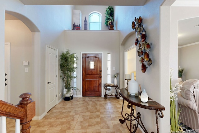 13026 Gordons Knl, San Antonio, TX 78253 - entryway featuring arched walkways, ornamental molding, a towering ceiling, and baseboards