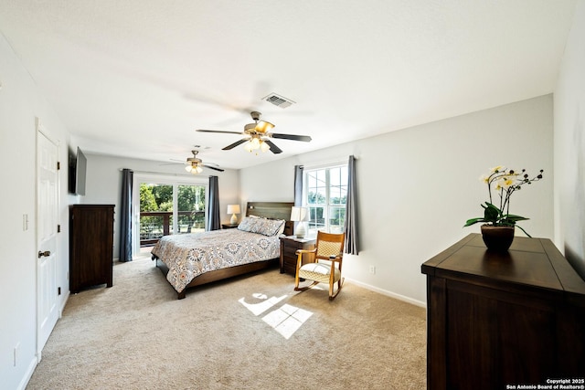 bedroom featuring light carpet, baseboards, multiple windows, and visible vents