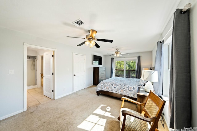 carpeted bedroom with visible vents, ceiling fan, ensuite bath, and baseboards