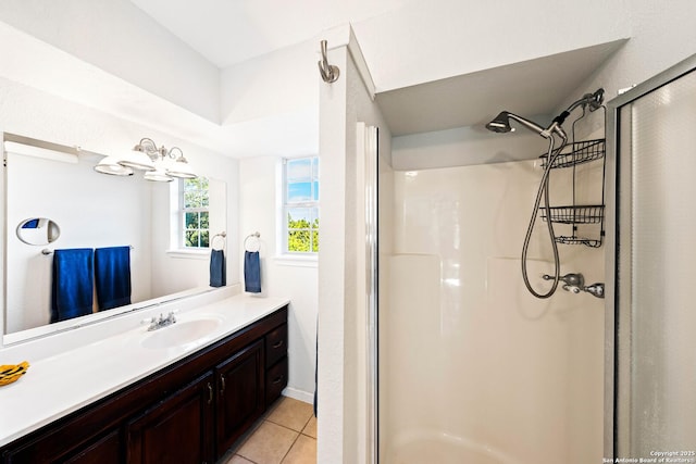 bathroom featuring tile patterned flooring, a shower stall, and vanity