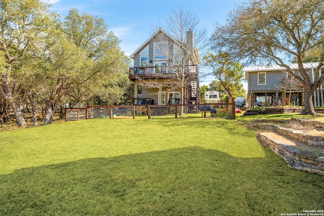 view of yard featuring fence and a deck