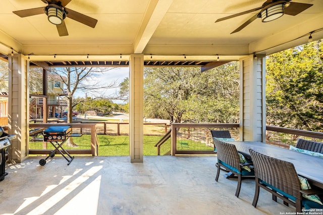 sunroom / solarium with a healthy amount of sunlight and ceiling fan