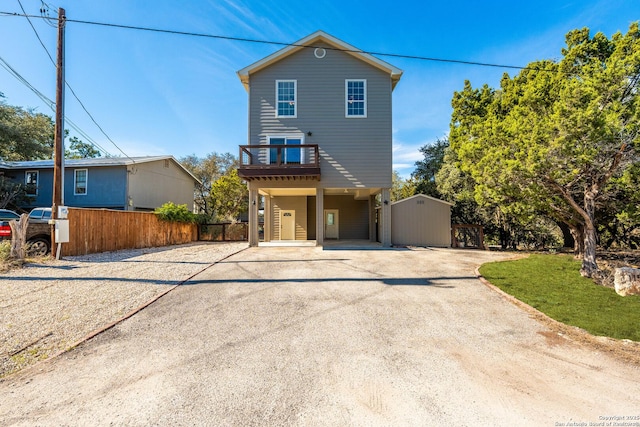 view of front of home with driveway and fence