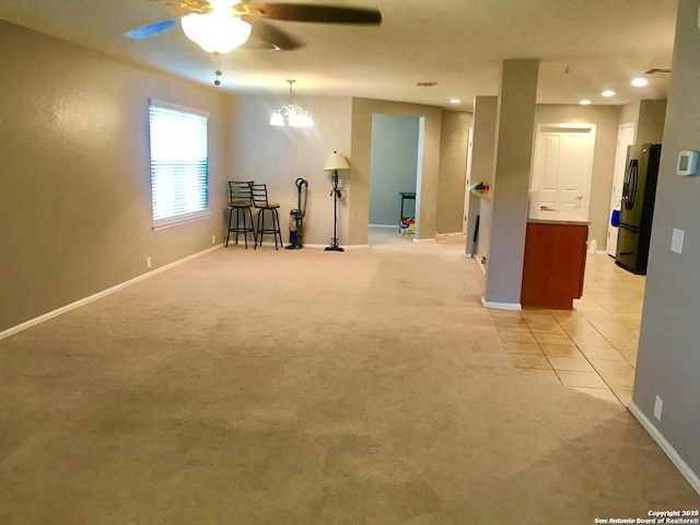 unfurnished room with light tile patterned floors, recessed lighting, light colored carpet, a ceiling fan, and baseboards