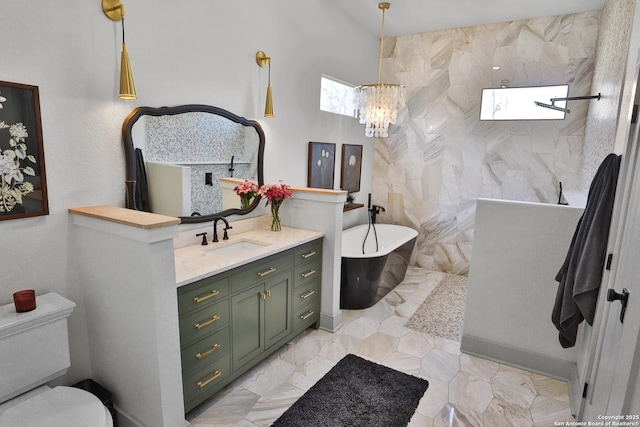 bathroom featuring toilet, a soaking tub, marble finish floor, walk in shower, and vanity