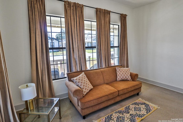 living area featuring carpet and baseboards