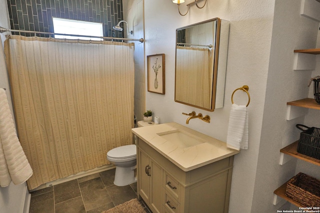 full bathroom featuring toilet, stone tile floors, and vanity