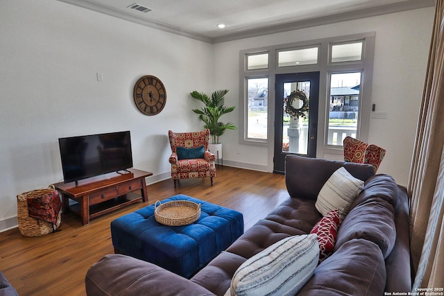 living room with recessed lighting, wood finished floors, visible vents, baseboards, and crown molding