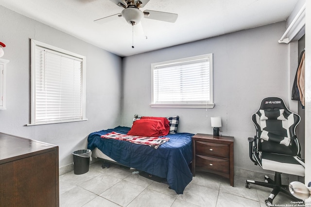 bedroom featuring light tile patterned floors and a ceiling fan